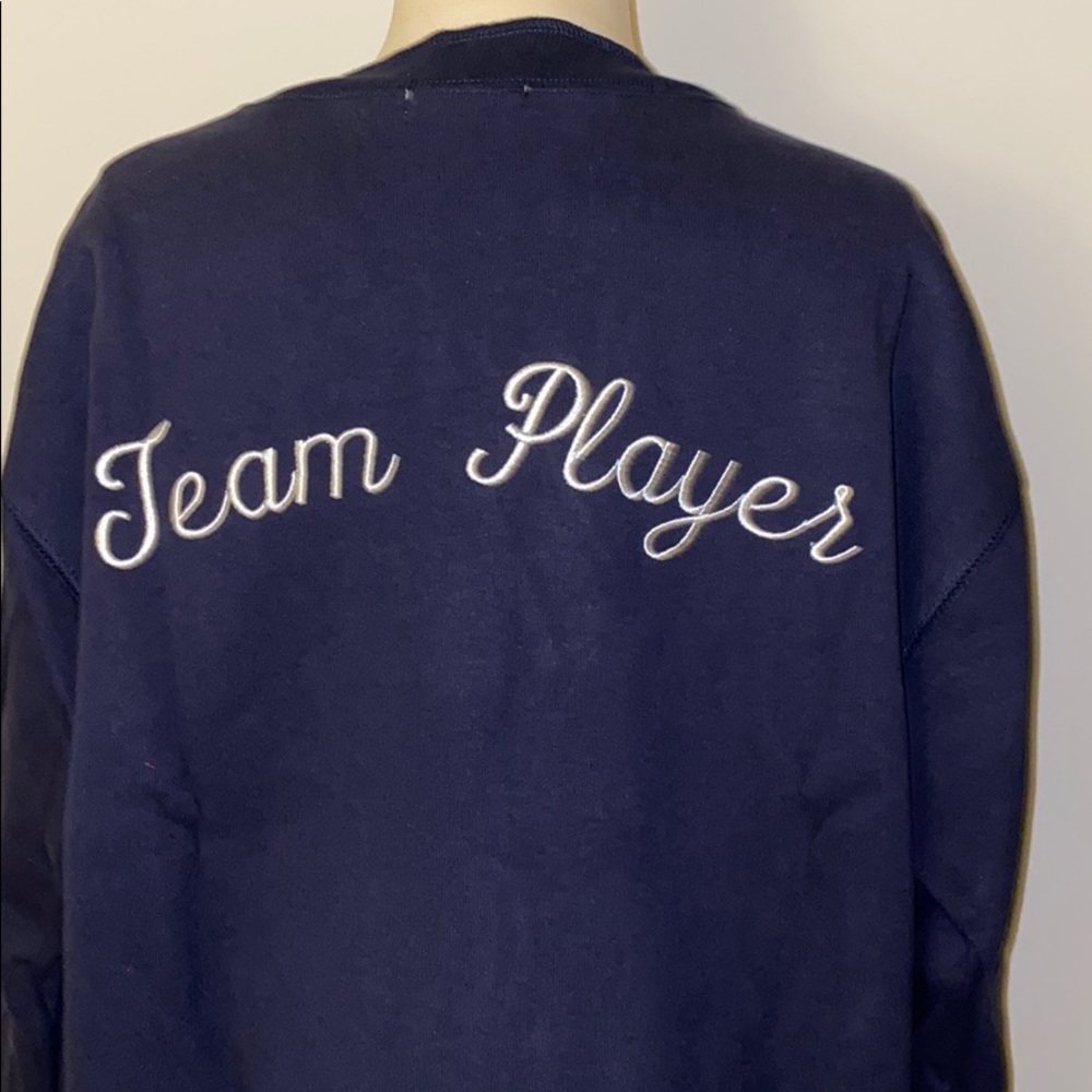 “Team Player” embroidered on back jacket blue